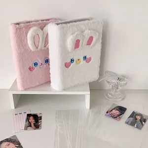 Close-up of plush bunny photocard binder with soft fur texture and ring binder detail