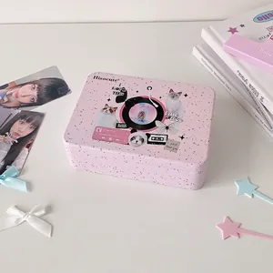 Detailed close-up of a pink vintage tin storage box with cute cat and retro prints