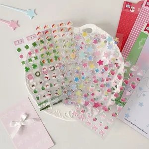 Detailed view of 3D resin strawberry and clover stickers for DIY journal decoration