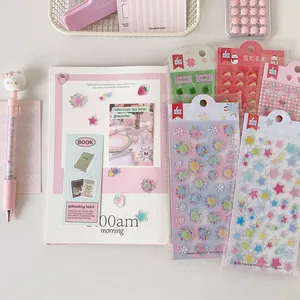Detail view of cute pink strawberry and clover stickers on a journal layout