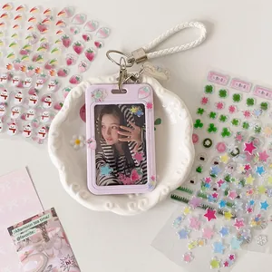 Detail of lavender card holder with strawberry stickers and white braided lanyard