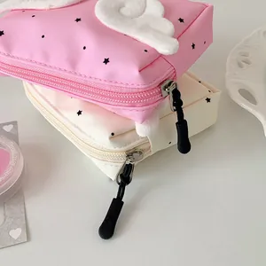 Close-up of mini wing storage pouches for earphones and cosmetics with star patterns