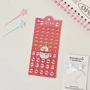 Detail of 3D snowman stickers with Christmas hats and maple leaves for DIY journals