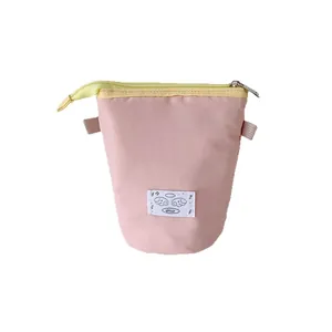 Minimalist high-capacity stationery storage bag with pink nylon fabric and yellow zipper