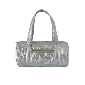 Quilted silver cylinder handbag featuring embossed bow patterns and heart zipper details