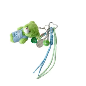 Cute green plush bear keychain with denim overalls, star pendant, and mini tennis racket