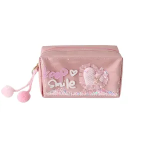 Pink large-capacity pencil case with Keep Smile lettering, sequins, and twin pom-poms