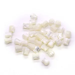 Macro shot of white tulip-shaped natural shell beads for DIY jewelry making