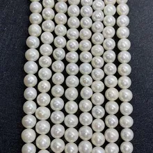 Detailed view of six strands of white near-round freshwater pearls for DIY jewelry making