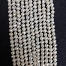 Macro detail of natural white freshwater pearls for DIY jewelry making and craft bead strands