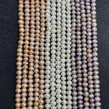 Detailed view of natural champagne, white, and purple freshwater pearl strands for DIY