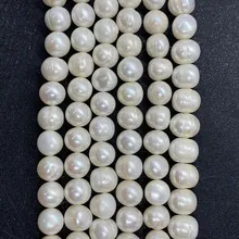 Macro detail of natural freshwater white pearls with natural luster for DIY jewelry