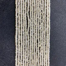 Detailed view of white freshwater pearls strands with lustrous finish on black background