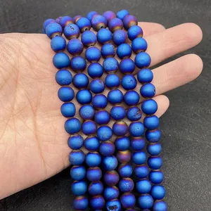 Detailed close-up of frosted blue agate beads with a metallic gradient finish for DIY jewelry