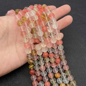 Macro shot of natural semi-precious stone beads showing texture and pink yellow colors