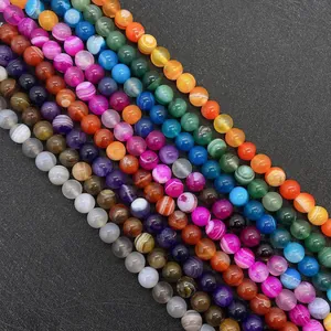Détails macro de perles d'agate rayées colorées avec texture de pierre naturelle pour DIY