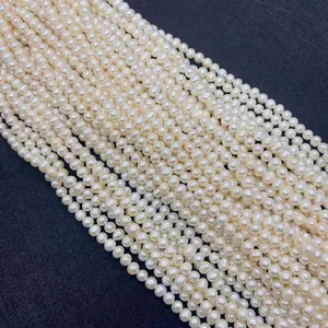 Detail of high-luster 3-5mm natural freshwater pearls in creamy white on dark background