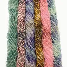 Macro detail of natural faceted amethyst beads in various colors for DIY jewelry making