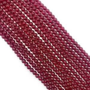 Macro shot of 6-10mm deep red polished glass garnet round beads for DIY jewelry making