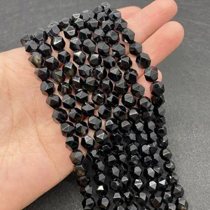 Macro shot of faceted black onyx round beads showing precise cuts and light refraction