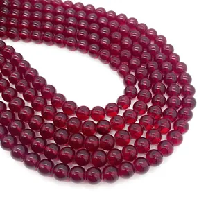 Macro view of polished deep red glass garnet beads for DIY jewelry and necklaces