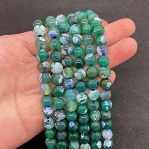 Macro shot of 8-10mm green dragon vein agate round beads with natural marble patterns