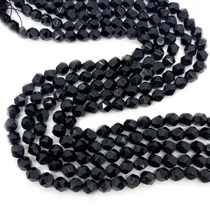 Macro view of faceted black onyx round beads with geometric cut surfaces for DIY jewelry