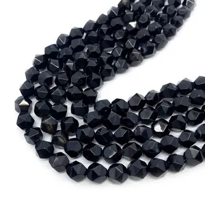 Macro view of faceted black onyx round beads showing precise cuts and glossy luster