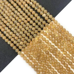 Natural yellow watermelon crystal beads for DIY jewelry making on dual-tone background