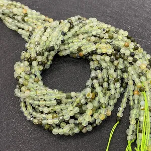 Detailed macro view of faceted prehnite beads showing green tones and natural inclusions