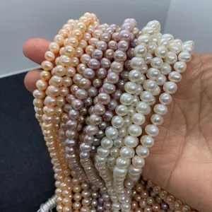 Macro detail of multi-color freshwater pearls in white, orange and purple hues