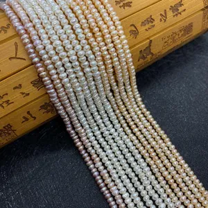 Macro shot of natural pearl beads in pink and white on a vintage bamboo mat background