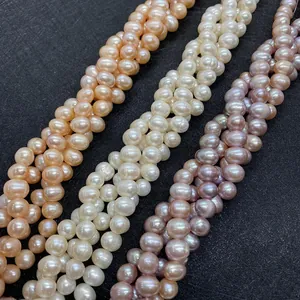 Detailed view of natural white pink and purple freshwater pearls on a black display board