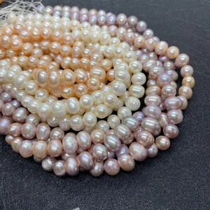 Macro detail of natural freshwater pearl strands in white pink and purple on black