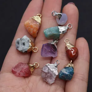 Macro shot of seven irregular natural stone pendants held in hand with metal clasps