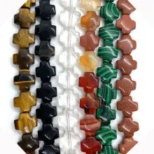 Close-up of assorted natural stone cross-shaped loose beads for DIY jewelry making