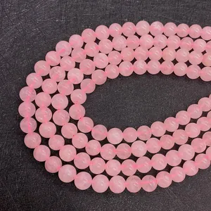 Macro shot of smooth 6-10mm pink rose quartz round beads for DIY jewelry making