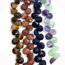 Detailed view of faceted heart-shaped natural stone beads in Tiger Eye and Sandstone