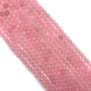 Polished natural rose quartz round beads for DIY jewelry making displayed on white background