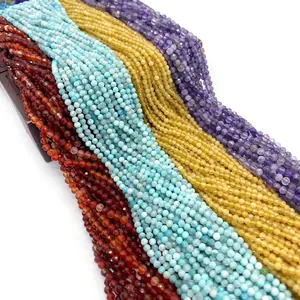 Close-up of 2mm faceted natural tiger eye and amethyst beads in mixed vibrant colors