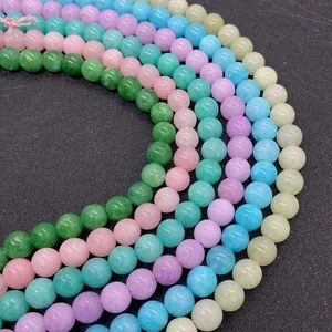 Macro shot of colorful round natural stone beads for DIY jewelry making in vibrant pastel tones