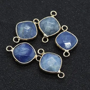 Primer plano de colgantes de piedra natural azul con conectores dorados de doble bucle
