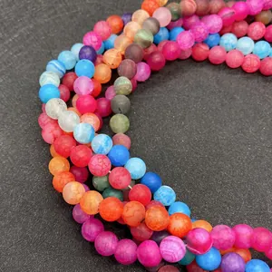 Close-up of frosted dragon vein agate beads in various vibrant colors with cracked texture