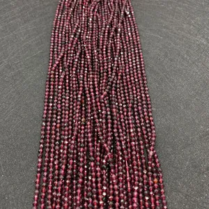 Macro detail of faceted garnet gemstone beads with deep red shimmer for DIY jewelry