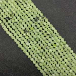 Macro shot of faceted light green prehnite stone beads for DIY jewelry making