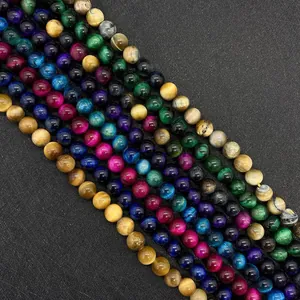 Macro detail of polished multi-color tiger eye round beads showing silk luster and cat eye effect