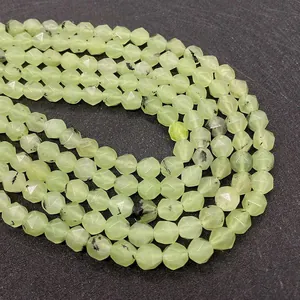 Macro detail of faceted light green prehnite beads with natural black tourmaline inclusions