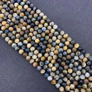 Macro shot of natural tiger eye stone beads with silky chatoyancy for DIY jewelry
