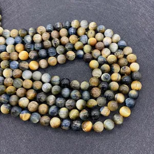 Macro shot of 6mm to 10mm round blue and gold tiger eye stone beads for DIY jewelry