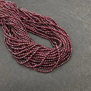 Macro view of faceted garnet beads in deep burgundy for DIY jewelry making and necklaces